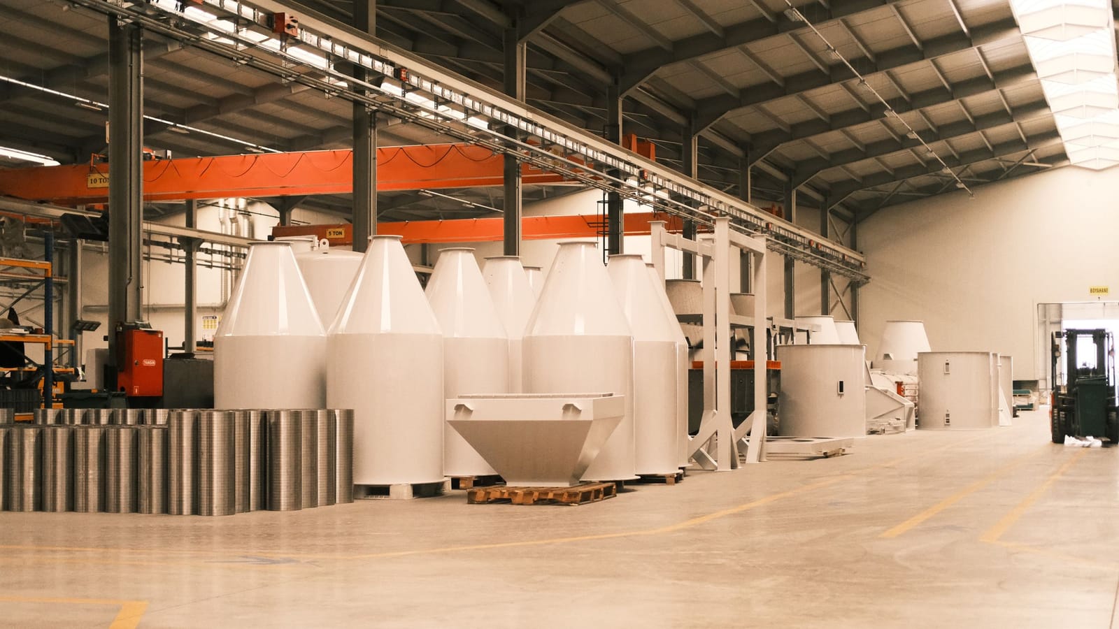 Interior of a metal manufacturing plant in Turkey with overhead cranes and steel silos