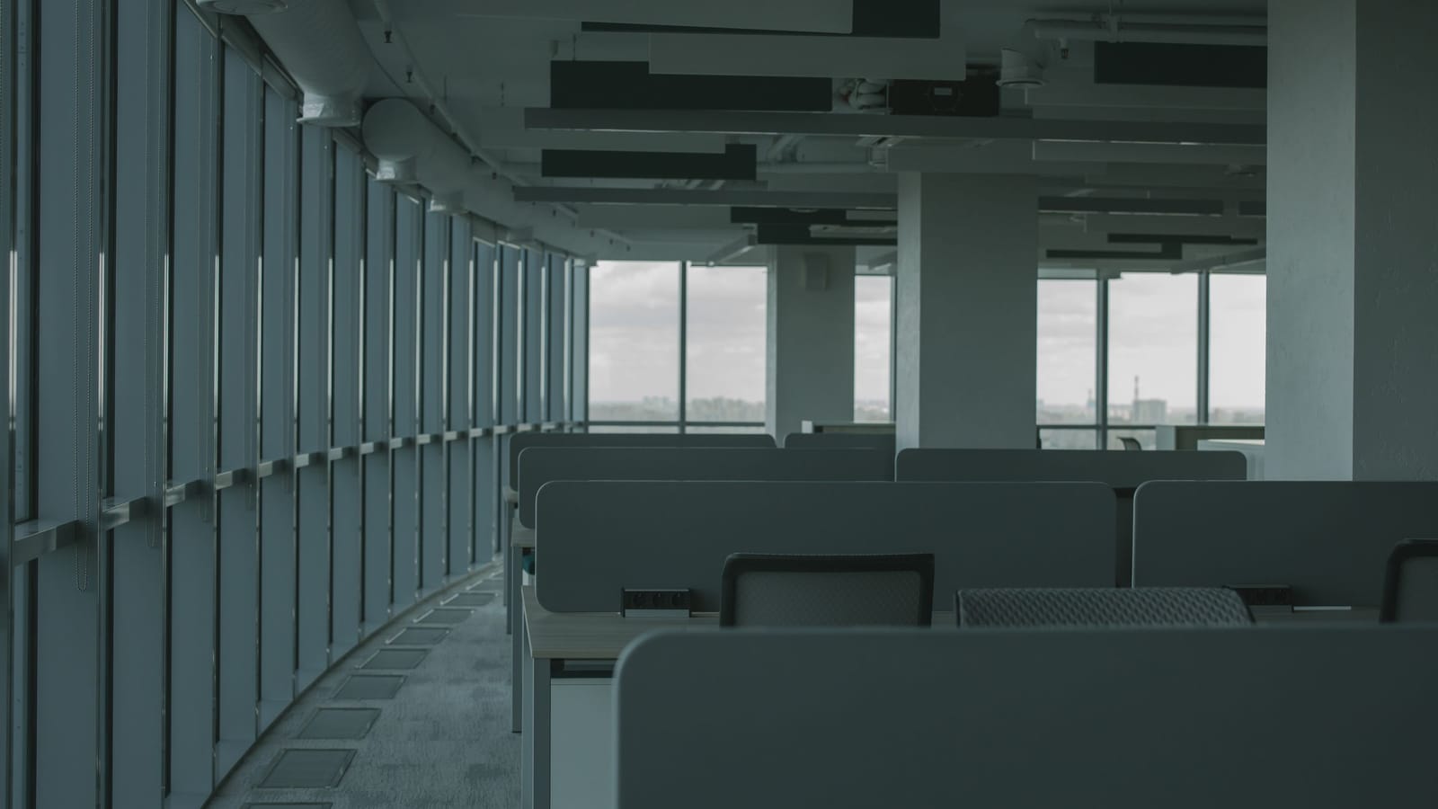 Empty open-plan office with glass walls on a high floor