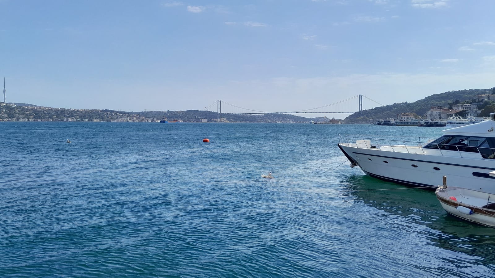 Boats moored on the Bosphorus with the bridge in the distance